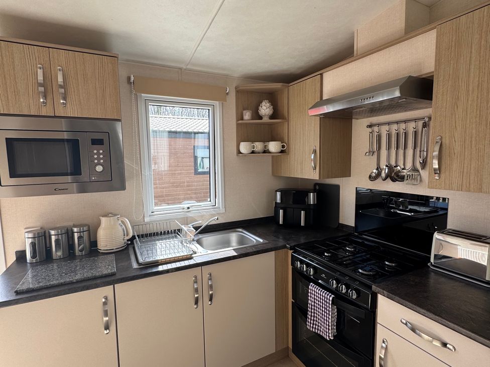 A kitchen with a sink and microwave at Golden Palm Resort - Holiday Accommodation 13363 Skegness