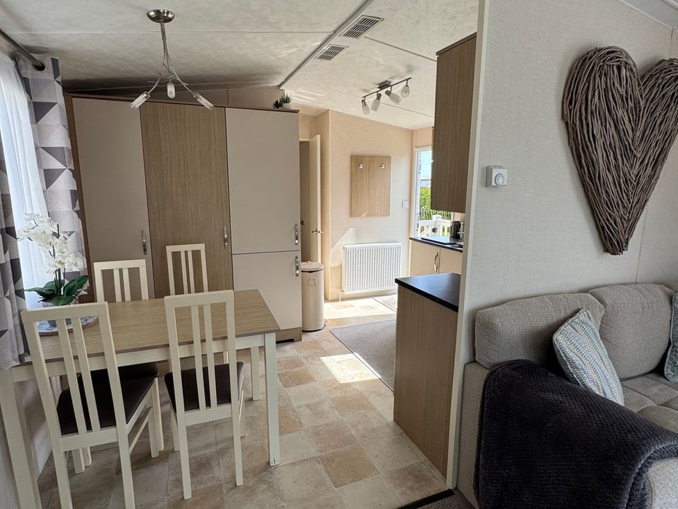 A dining area with a table and chairs at Golden Palm Resort - Holiday Accommodation 13363 Skegness