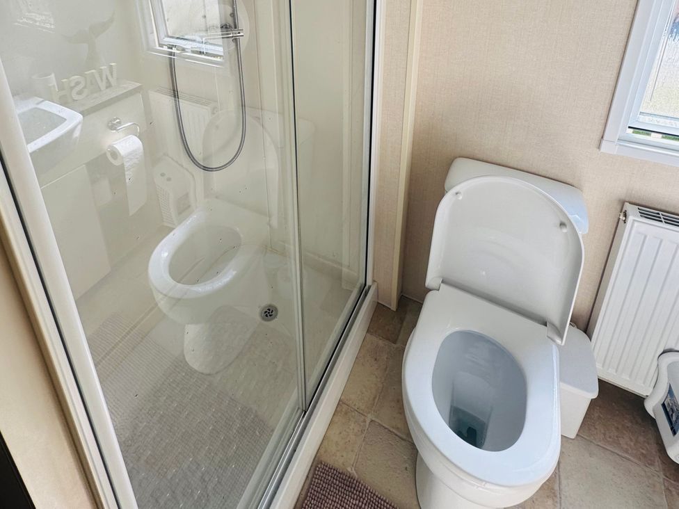 A bathroom with a shower and toilet at Golden Palm Resort - Holiday Accommodation 13363 Skegness