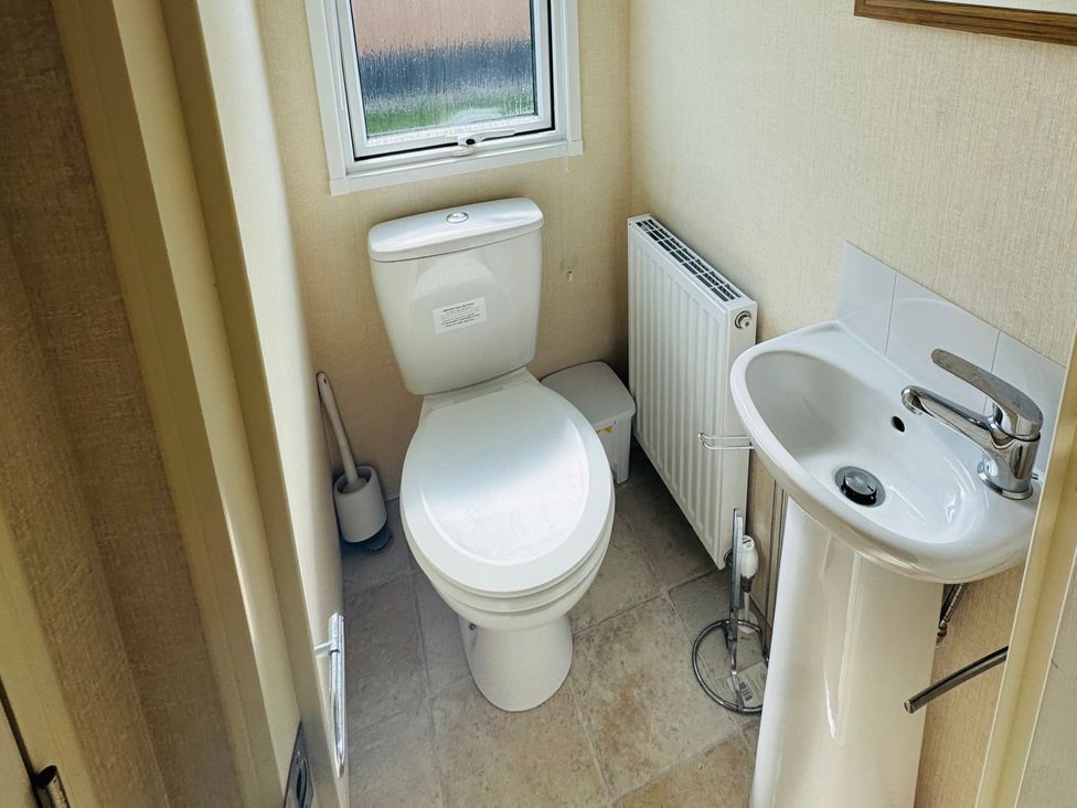 A bathroom featuring a toilet and sink at Golden Palm Resort - Holiday Accommodation 13363 Skegness