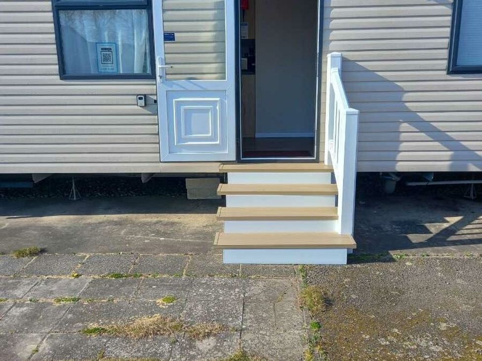 a set of steps leading to a door of a mobile home at Skegness Holiday Park - Holiday Accommodation 13968, Skegness