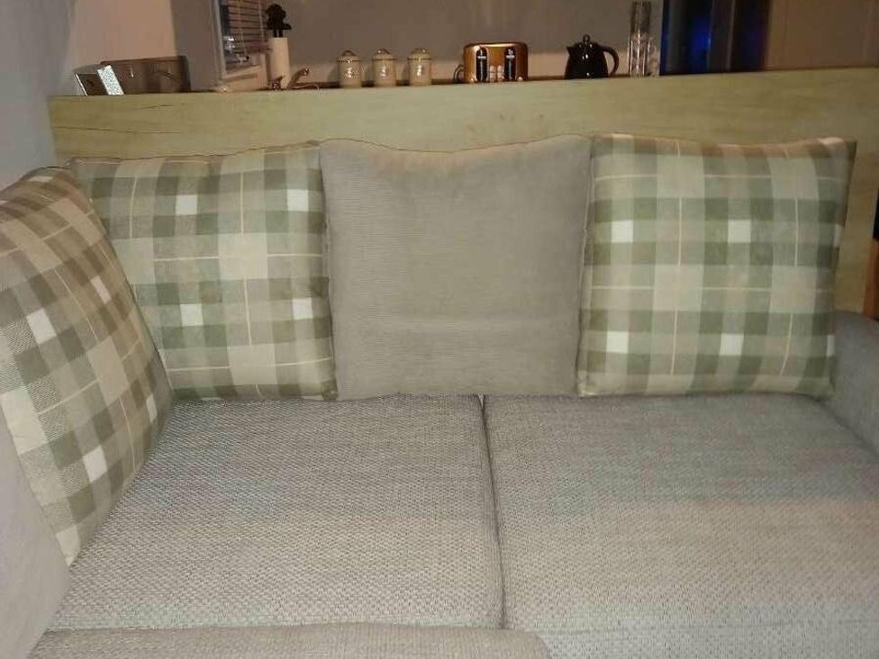 a sofa with plaid cushions and a textured fabric at Skegness Holiday Park - Holiday Accommodation 13968, Skegness