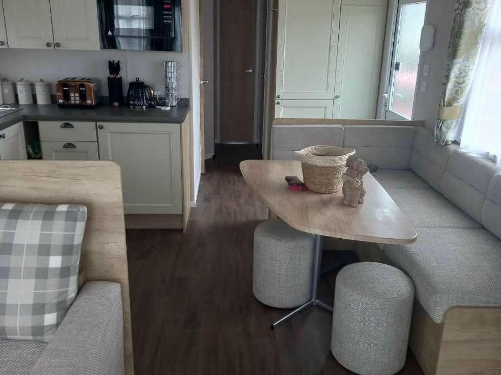 a dining area with a round table and seating in Skegness Holiday Park - Holiday Accommodation 13968, Skegness