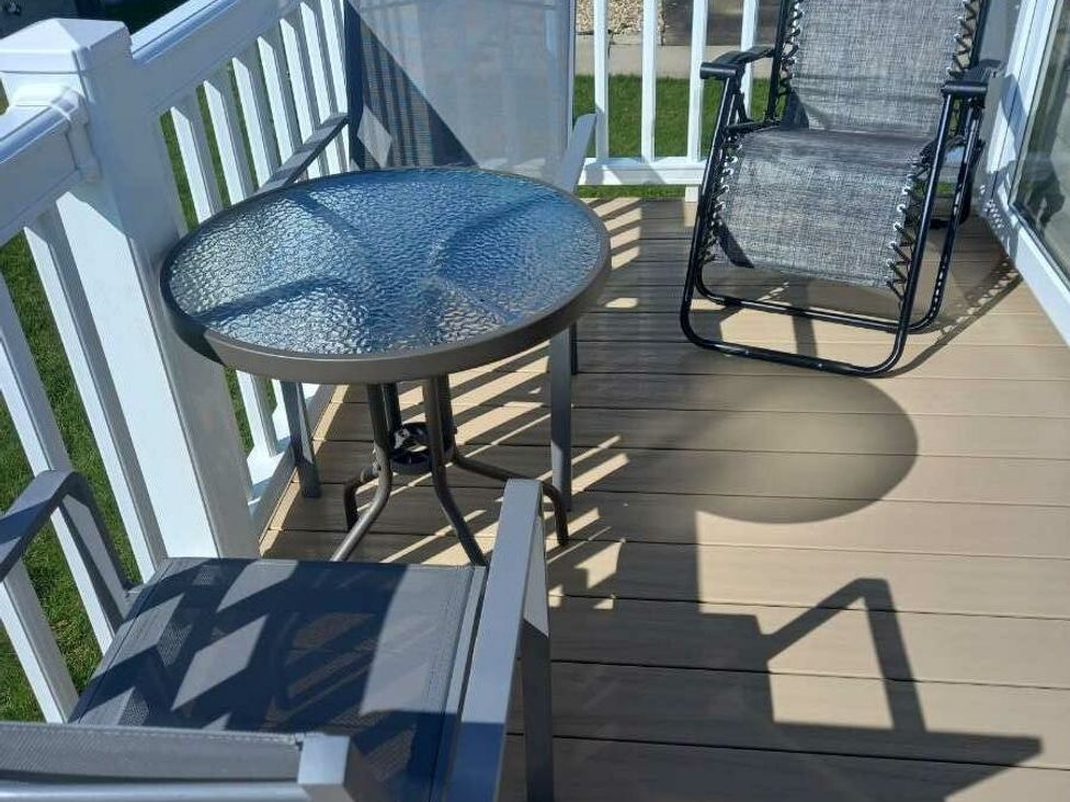 a balcony with a table and two chairs at Skegness Holiday Park - Holiday Accommodation 13968 Skegness