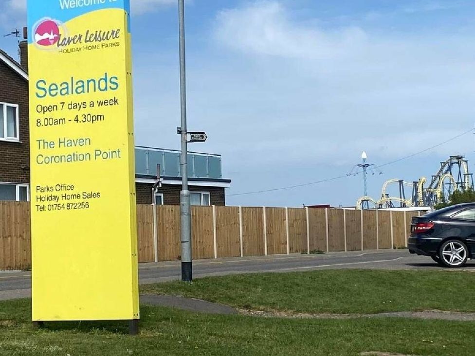 a sign for Sealands Holiday Home Parks with hours and contact information at Sealands Caravan Park - Holiday Accommodation 15223 in Ingoldmells