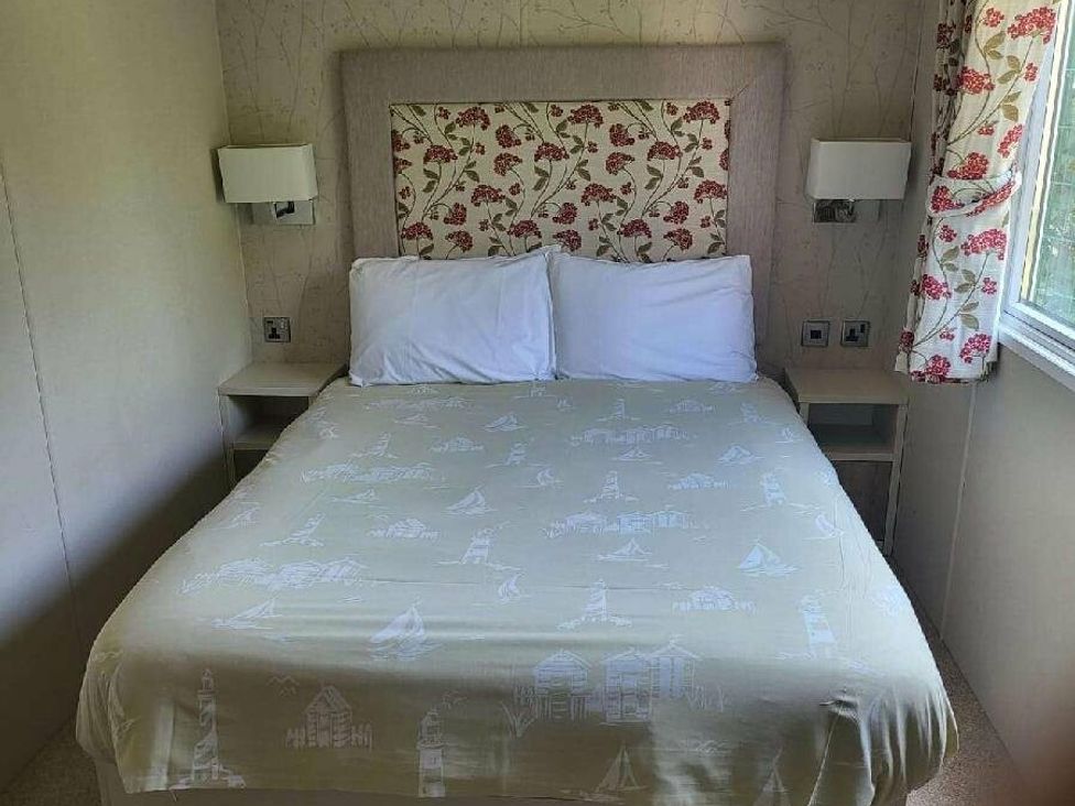 a bedroom with a double bed and bedside lights at Hopton Holiday Village - Holiday Accommodation 15473 in Great Yarmouth