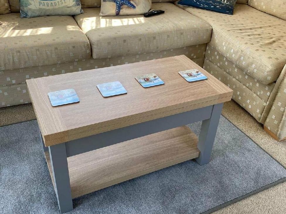 a coffee table with coasters on top in a seating area at Lyons Sunnysands Holiday Park - Holiday Accommodation 15526 in Barmouth