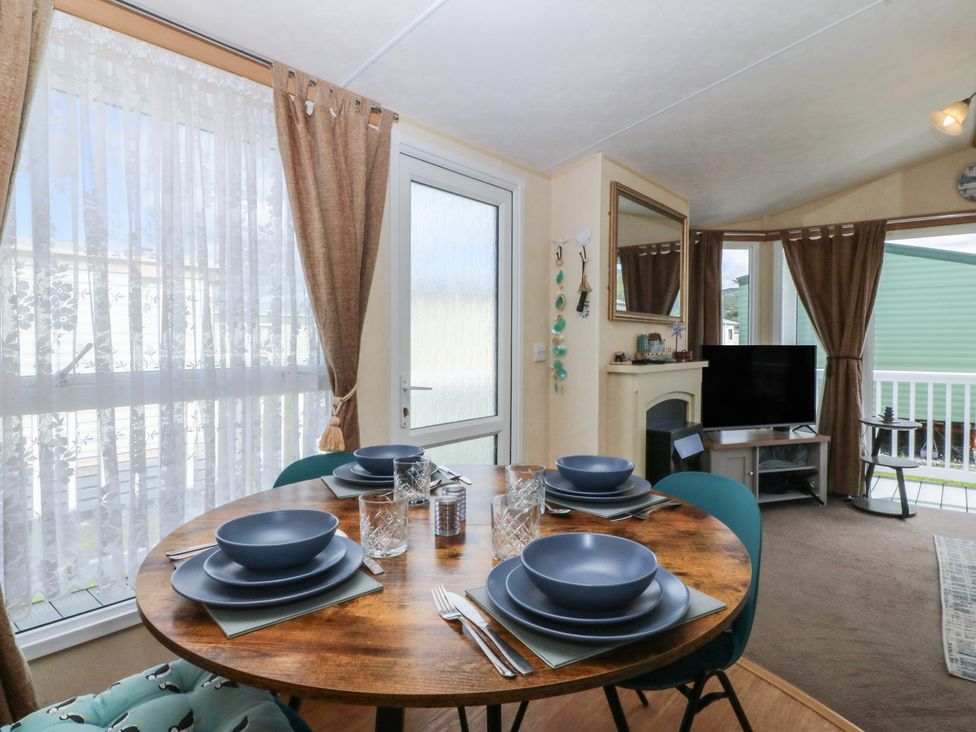A dining room with a table set for four at Sunnysands in Talybont near Barmouth