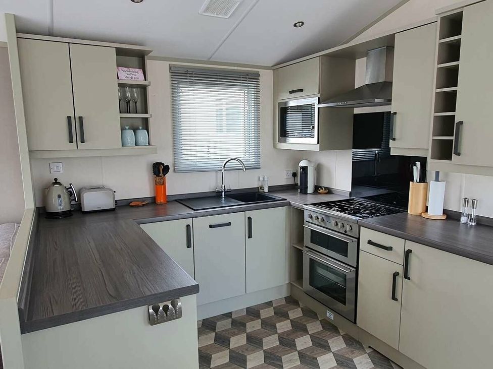 a modern kitchen with cabinets and appliances at Shorefield Country Park - Holiday Accommodation 15558, Milford On Sea