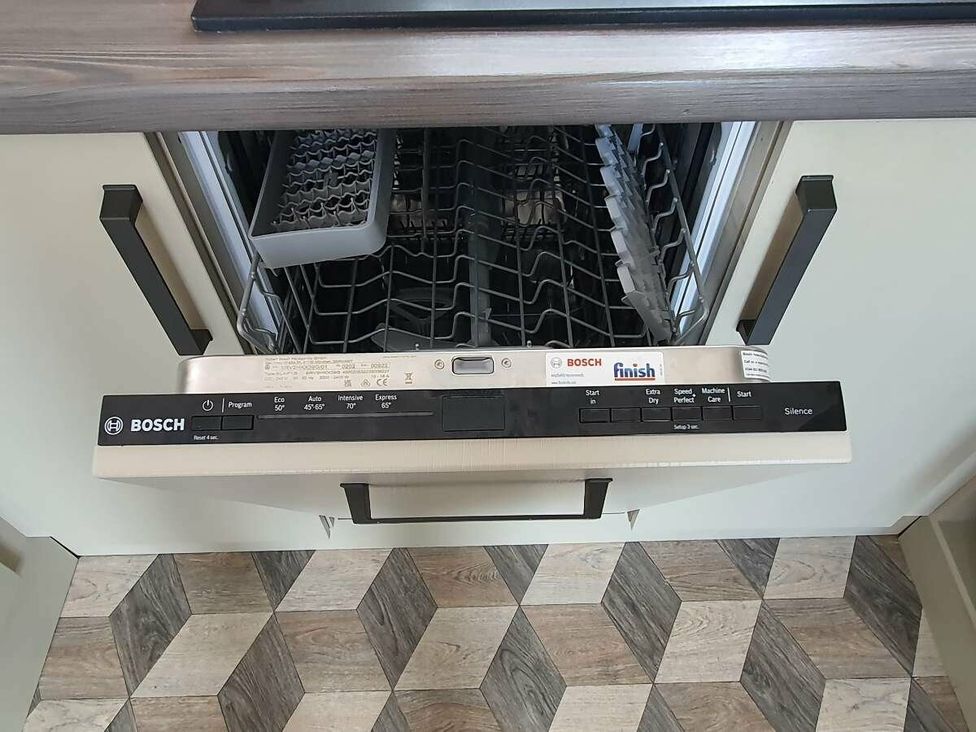 a Bosch dishwasher with its door open showing the interior and control panel at Shorefield Country Park - Holiday Accommodation 15558, Milford On Sea
