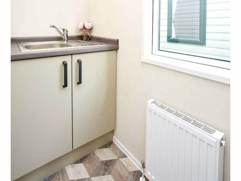 a kitchenette with a sink and cupboards at Shorefield Country Park - Holiday Accommodation 15558 in Milford On Sea