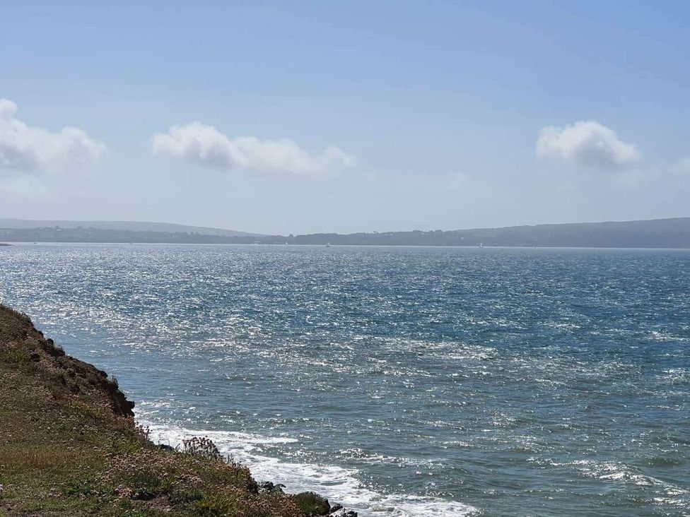 a coastal view with water and distant hills at Shorefield Country Park - Holiday Accommodation 15558 Milford On Sea