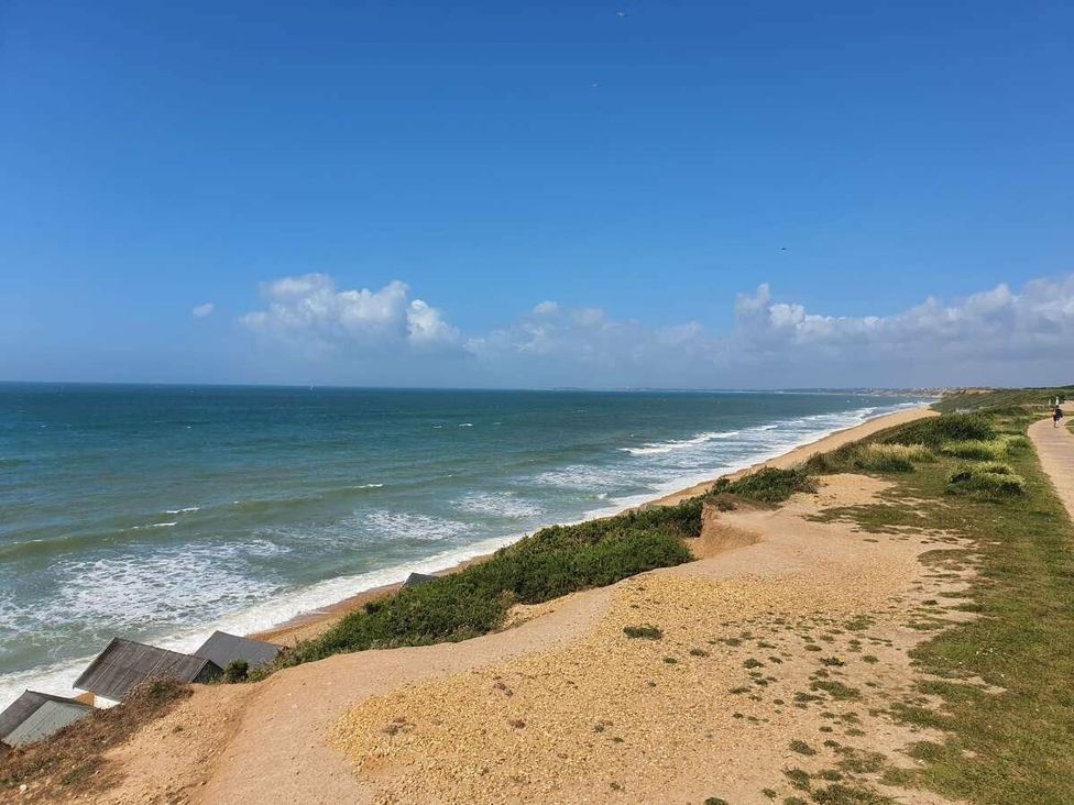 a coastal view with waves and cliffs at Shorefield Country Park - Holiday Accommodation 15558 Milford On Sea