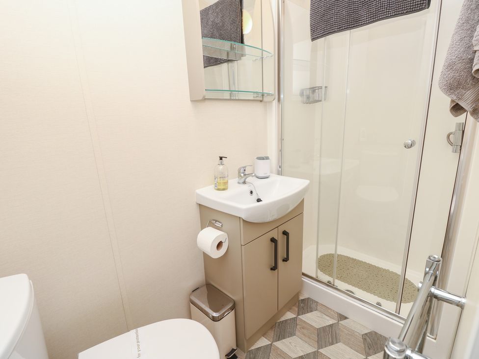 A bathroom with a sink and shower at Pine Tree Lodge - Shorefield Country Park Milford On Sea