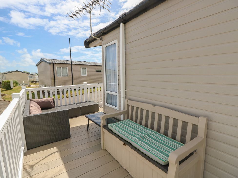 A porch with seating and a table at Pine Tree Lodge - Shorefield Country Park Milford On Sea