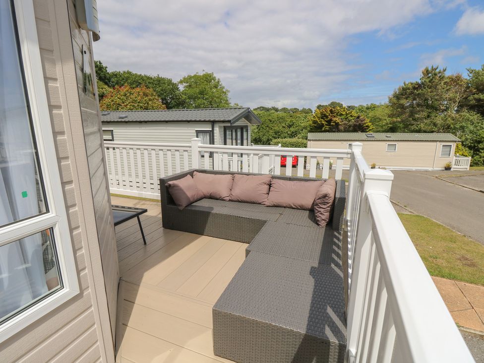 A seating area with a sofa and table at Pine Tree Lodge - Shorefield Country Park Milford On Sea