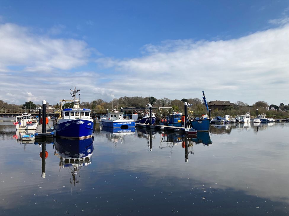 Boats docked at a river under a clear sky at Pine Tree Lodge - Shorefield Country Park Milford On Sea