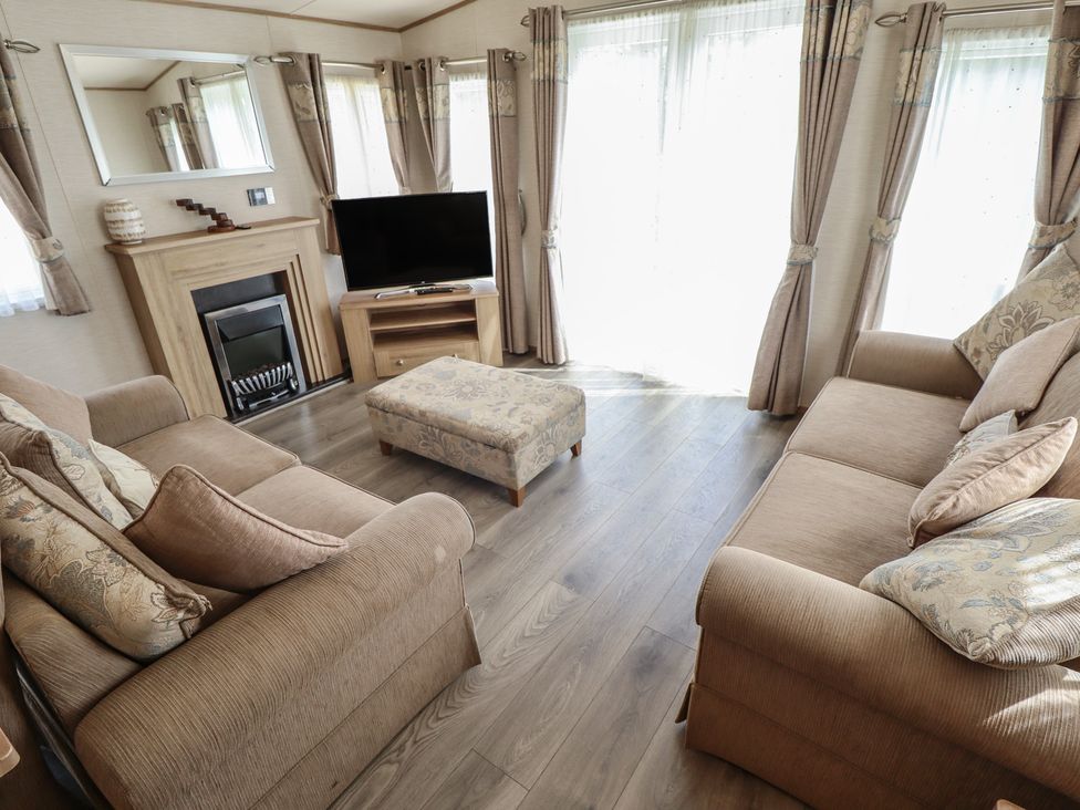 A living room with sofa, television and fireplace at Tattershall Lakes Country Park - Holiday Accommodation 16408, Tattershall