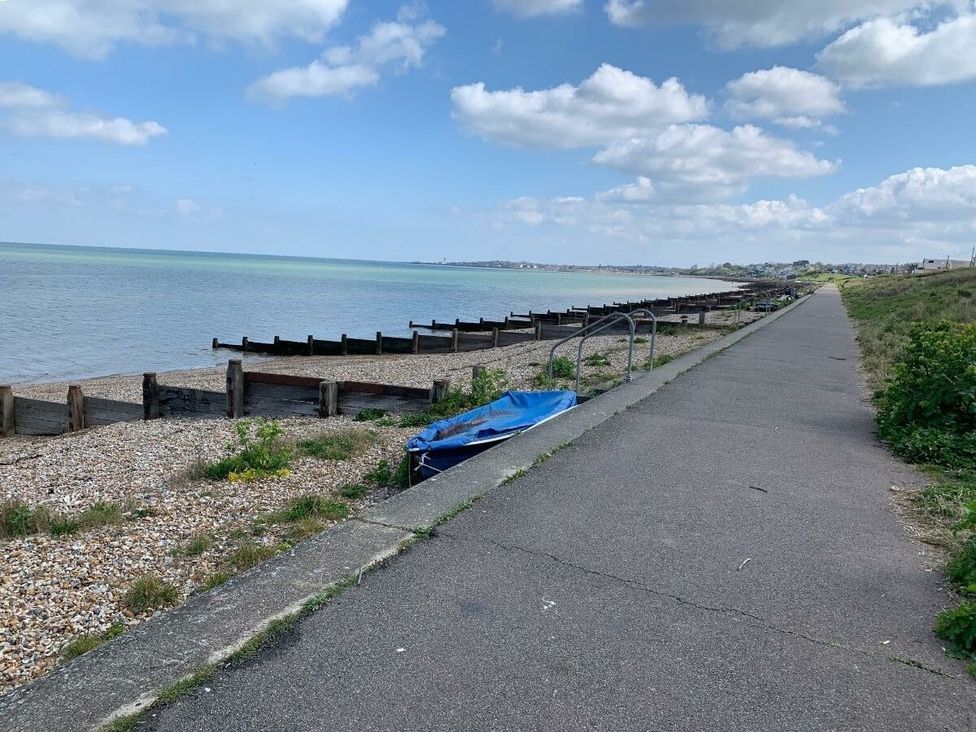 a seaside path with a coastline and blue sky at Alberta Holiday Park - Holiday Accommodation 16770 in Whitstable
