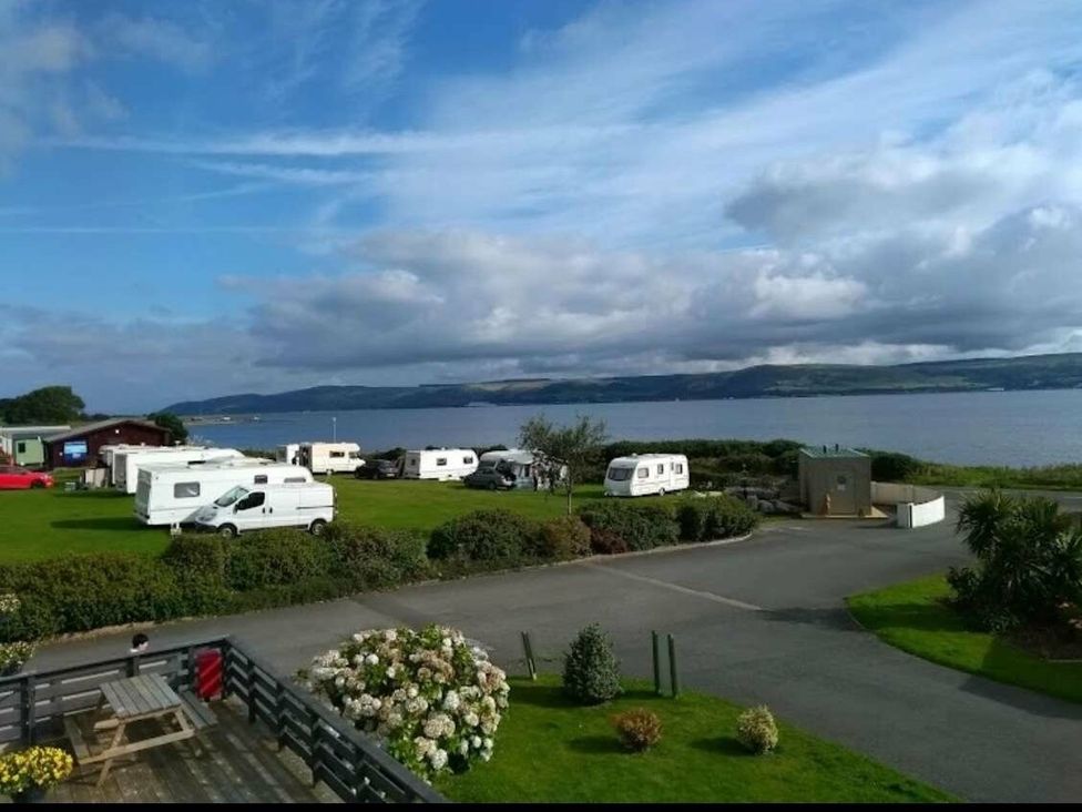 a view of caravans and green spaces by the water at WigBay Holiday Park - Holiday Accommodation 16774, Stranraer
