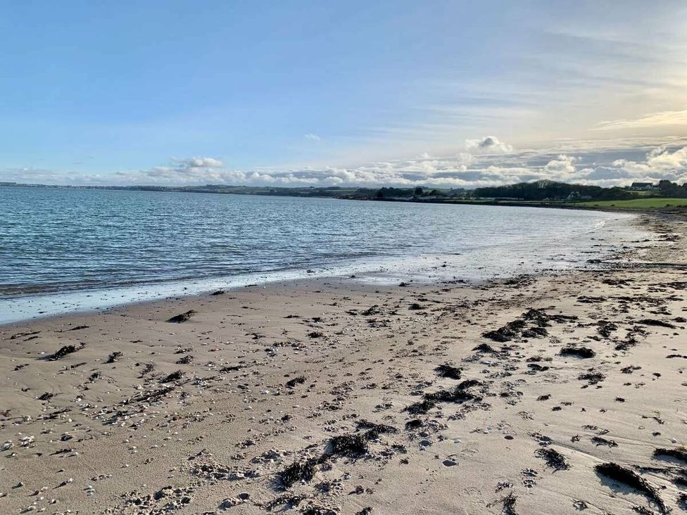 a beach with sand and water at WigBay Holiday Park - Holiday Accommodation 16774 Stranraer