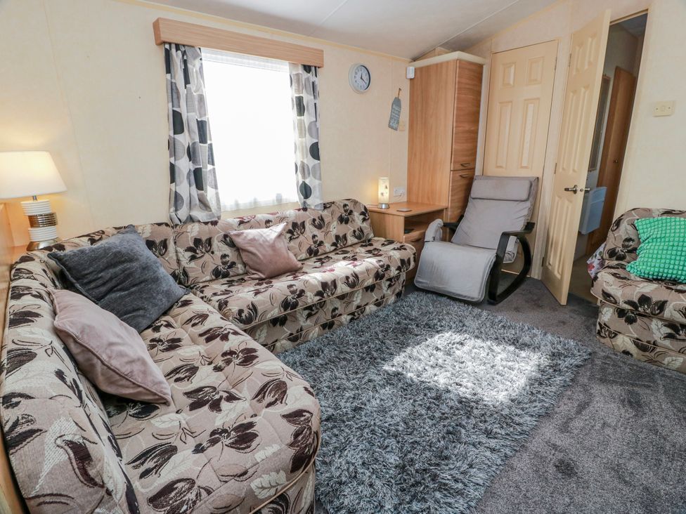 A living room with a sofa and armchair at WigBay Holiday Park - Holiday Accommodation 16774 Stranraer