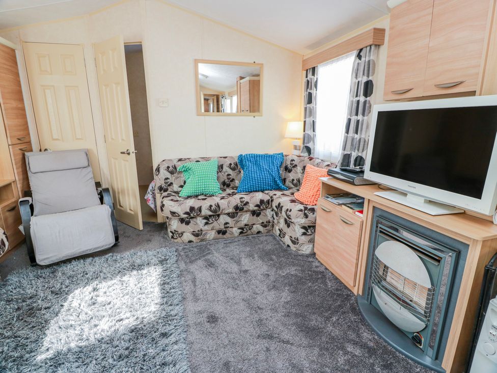 A living room with a sofa and armchair at WigBay Holiday Park - Holiday Accommodation 16774 in Stranraer