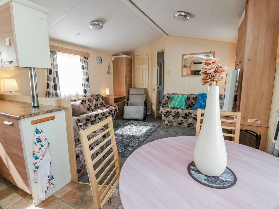 A living room with a table and sofa at WigBay Holiday Park - Holiday Accommodation 16774 Stranraer