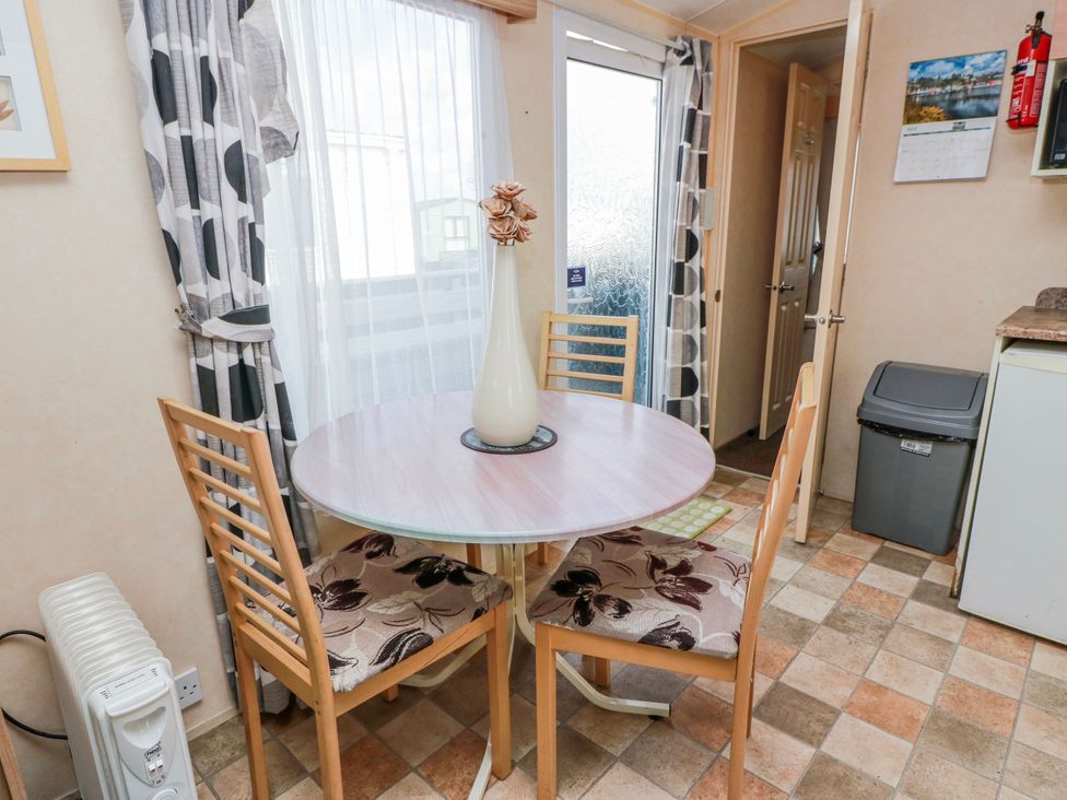 A dining room with a table and chairs at WigBay Holiday Park - Holiday Accommodation 16774 Stranraer