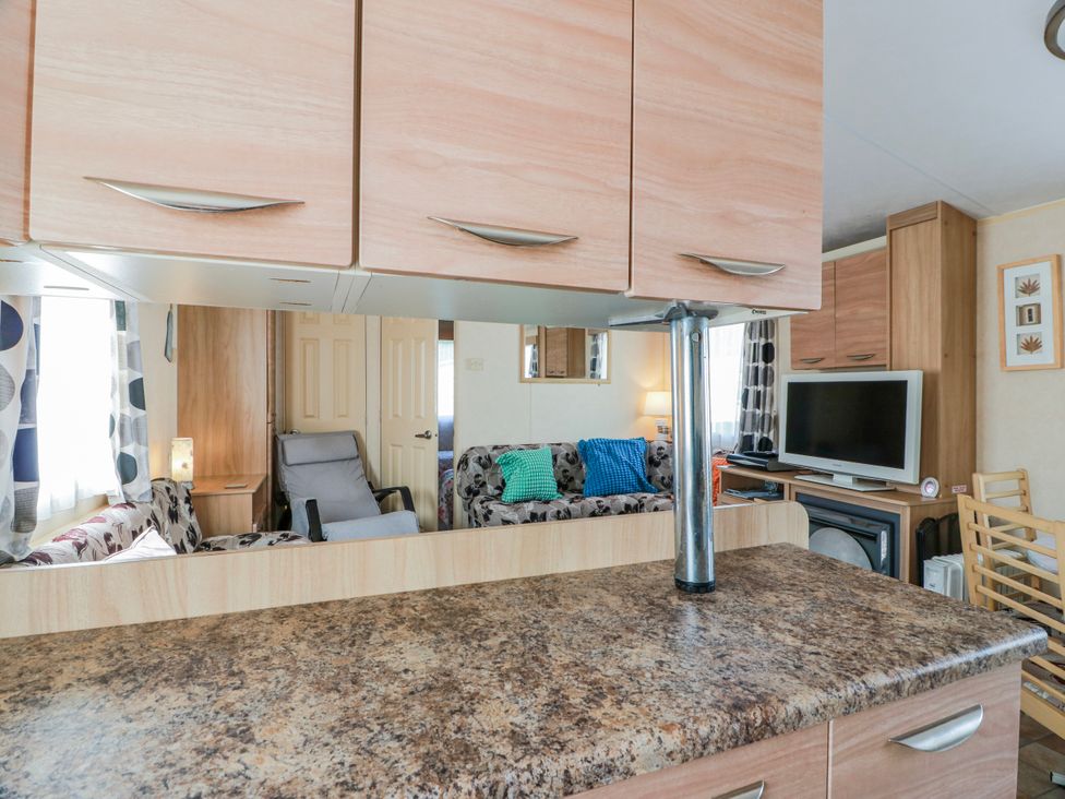 A living room with a sofa and television at WigBay Holiday Park - Holiday Accommodation 16774 Stranraer