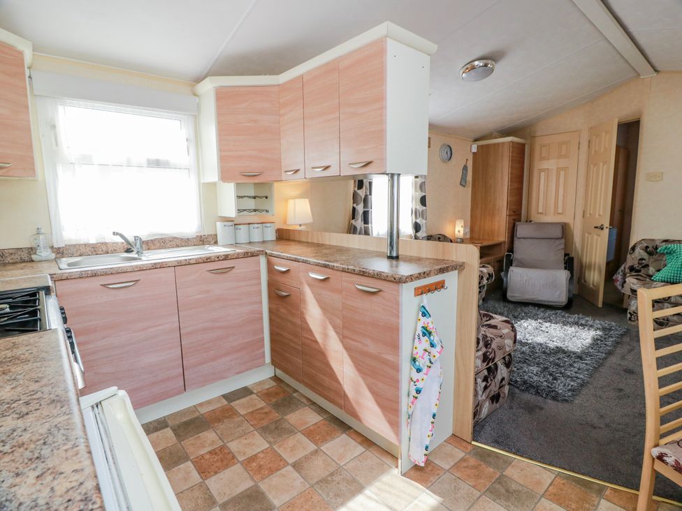 A kitchen with cabinets and a stove at WigBay Holiday Park - Holiday Accommodation 16774, Stranraer