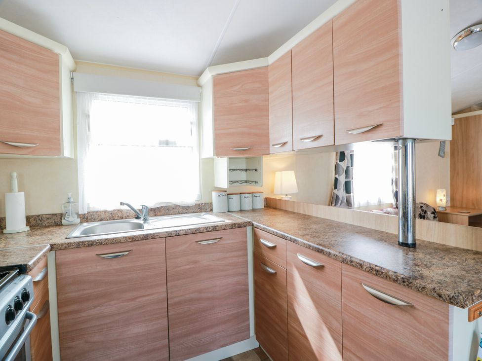 A kitchen with a sink and cupboards at WigBay Holiday Park - Holiday Accommodation 16774 Stranraer