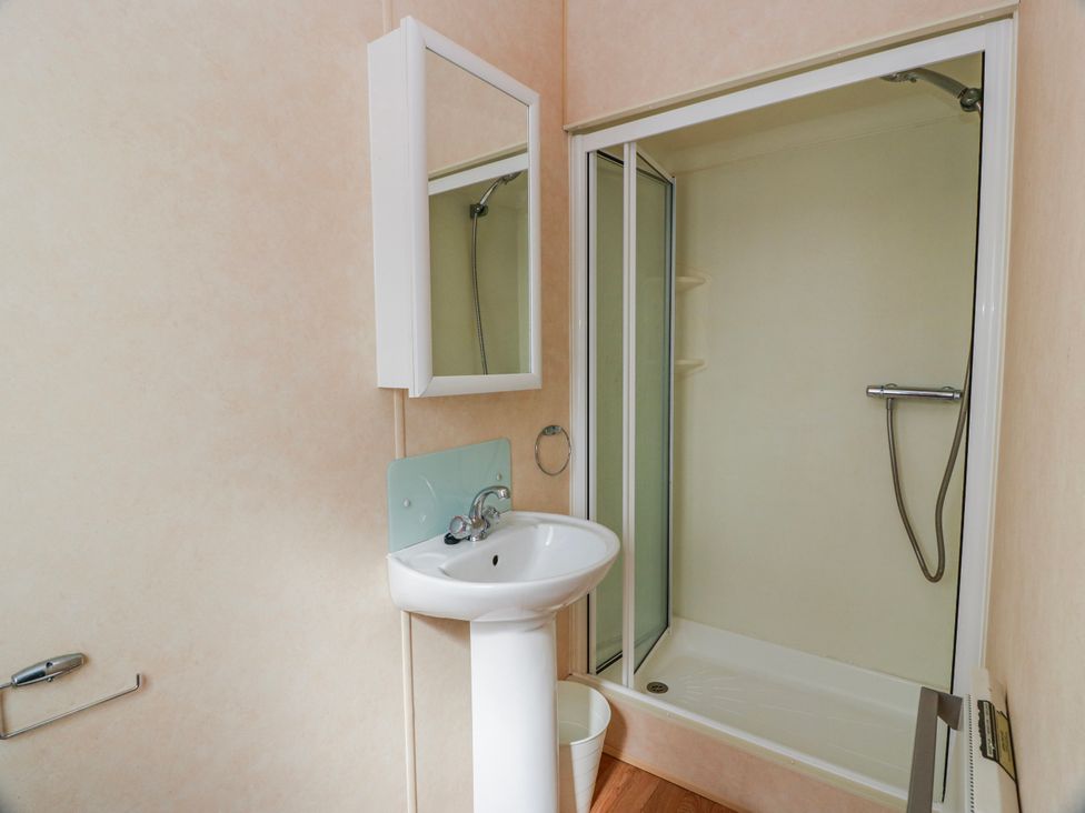 A bathroom with a sink and shower at WigBay Holiday Park - Holiday Accommodation 16774, Stranraer