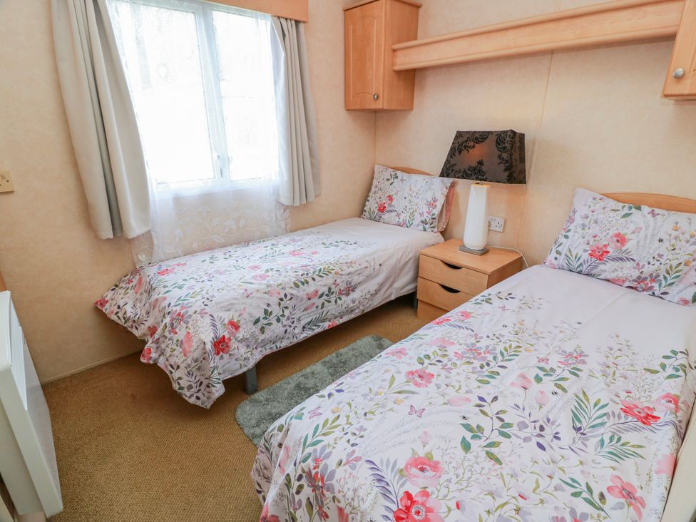 A bedroom with two beds and a window at WigBay Holiday Park - Holiday Accommodation 16774 Stranraer