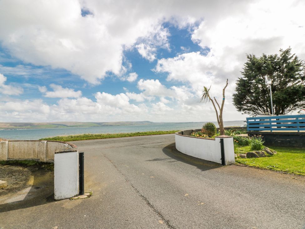 A view of a coastal road leading to the sea at WigBay Holiday Park - Holiday Accommodation 16774 Stranraer