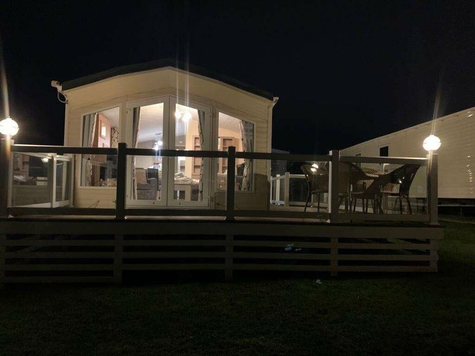 a holiday accommodation with a deck and outdoor seating at Chesil Beach Holiday Park - Holiday Accommodation 16933 in Weymouth