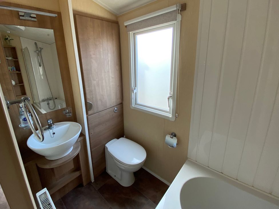 A bathroom with a sink, toilet, and bathtub at Chesil Beach Holiday Park - Holiday Accommodation 16933 in Weymouth