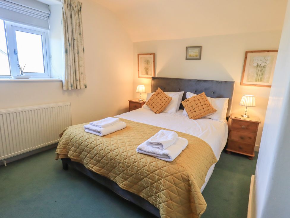 A bedroom with a bed and bedside tables at 2 Lupton Hall Cottages in Carnforth