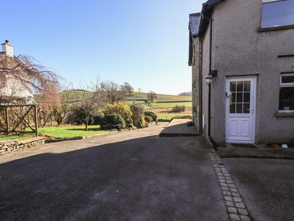 An outdoor view of a pathway and garden at 2 Lupton Hall Cottages Carnforth