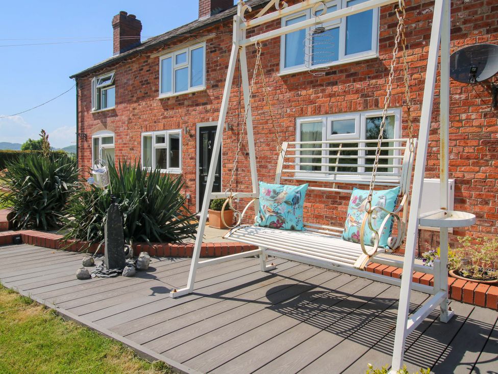 An outdoor swing with cushions at Fron-Haul near Llansantffraidd-Ym-Mechain