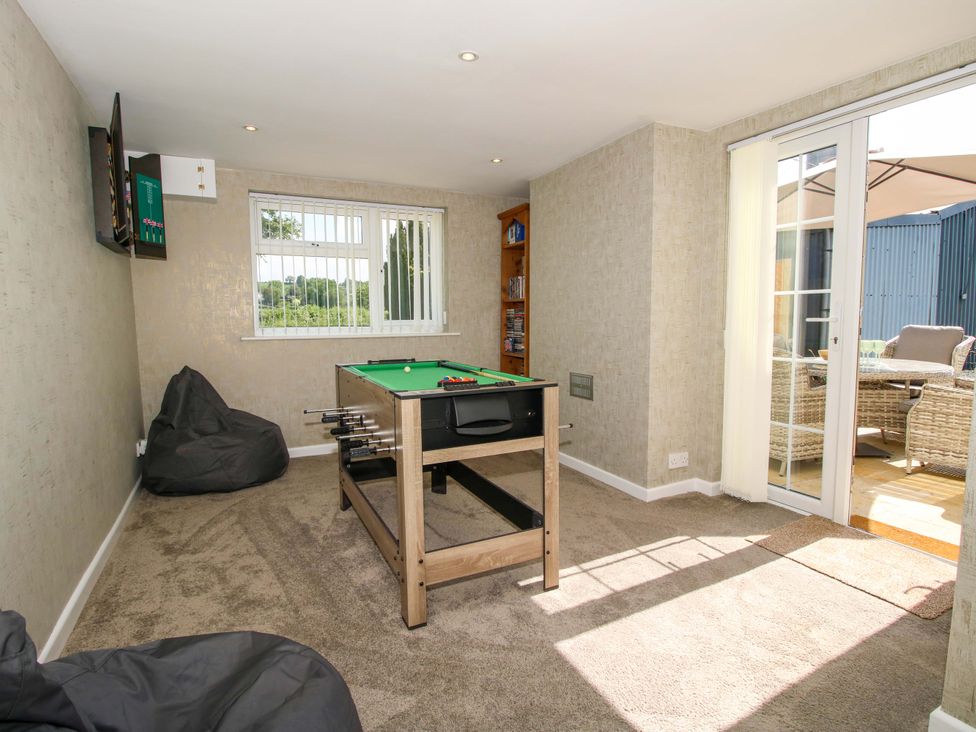 A snug with a pool table and bean bags at Fron-Haul Near Llansantffraidd-Ym-Mechain