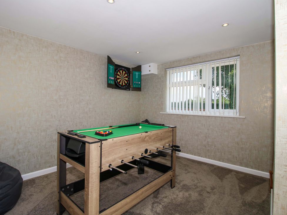 A games room with a pool table and a darts board at Fron-Haul near Llansantffraidd-Ym-Mechain