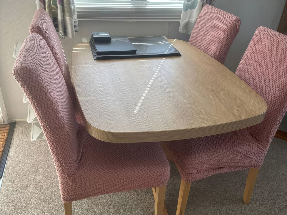A dining room with a table and chairs at Freshwater Beach Holiday Park - Holiday Accommodation 17116 near Burton Bradstock
