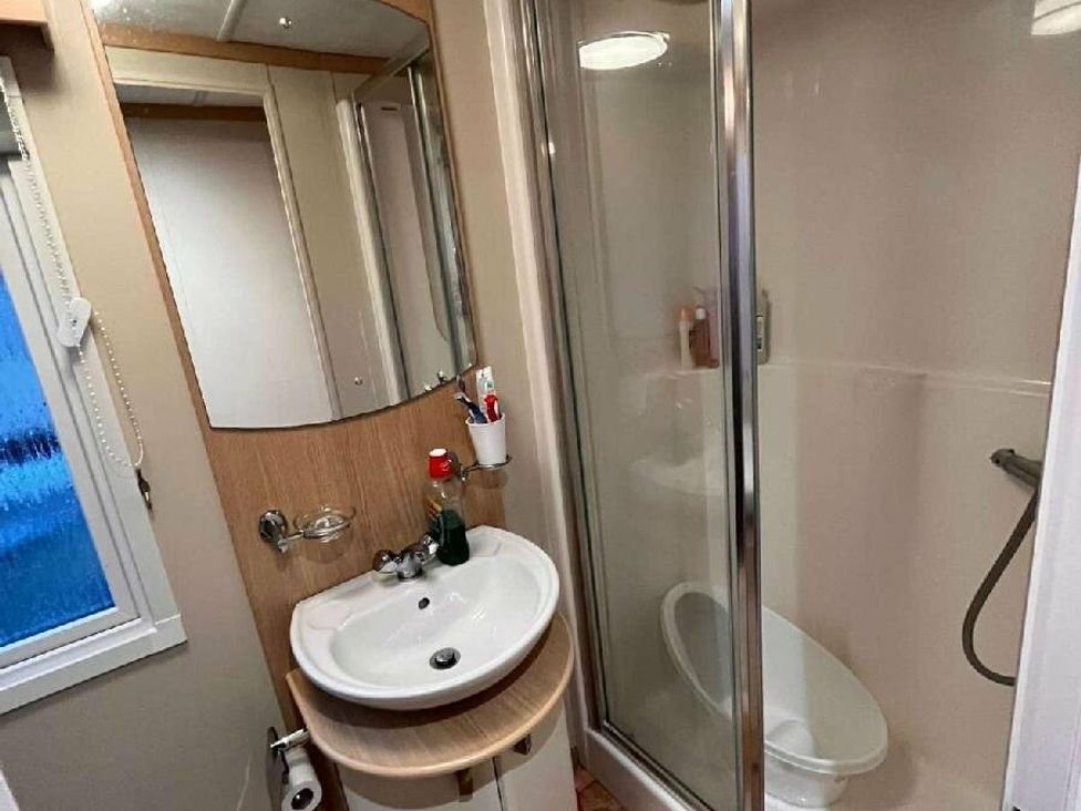 a bathroom featuring a shower, sink, and toilet at Golden Anchor Holiday Park - Holiday Accommodation 17383 in Skegness
