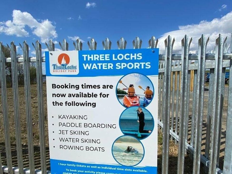 a sign for Three Lochs Water Sports with booking information at Three Lochs Holiday Park - Holiday Accommodation 17424 in Stranraer