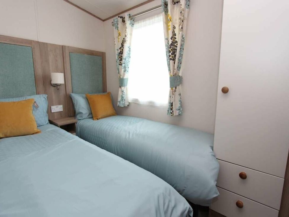 a bedroom with two single beds and a wardrobe at Tattershall Lakes Country Park - Holiday Accommodation 17807 in Tattershall