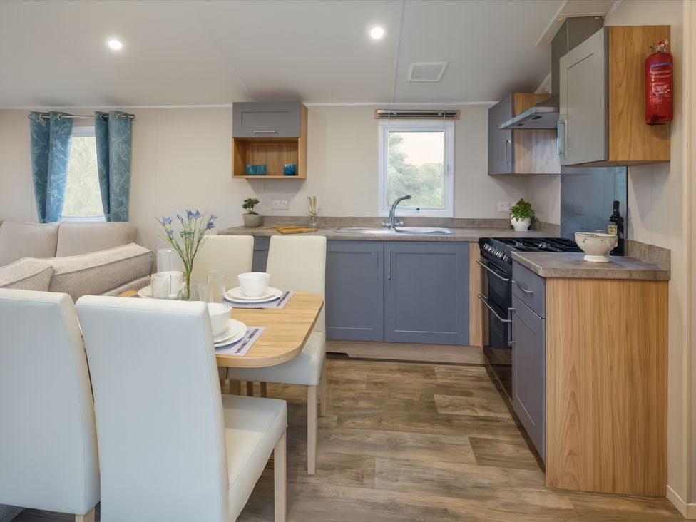 A kitchen with a dining area and a view at Marton Mere Holiday Village - Holiday Accommodation 17890, Blackpool