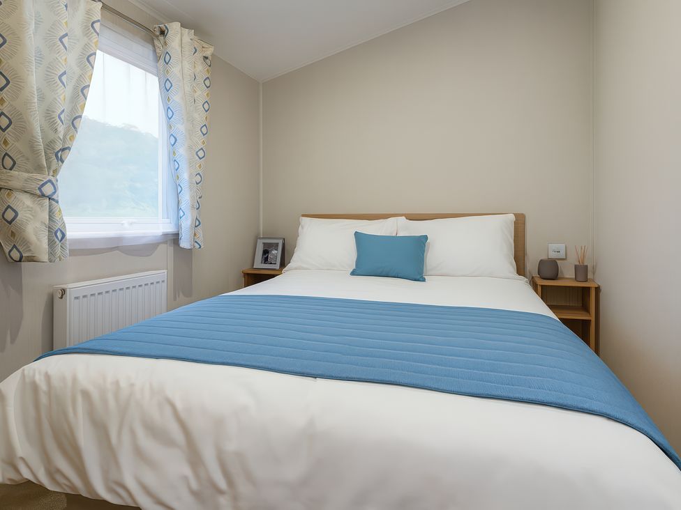 A bedroom with a bed and window at Marton Mere Holiday Village - Holiday Accommodation 17890 in Blackpool