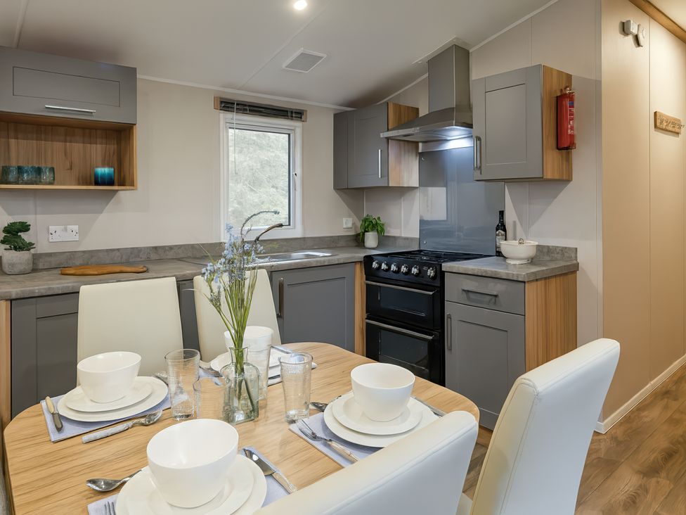 A kitchen with dining table and chairs at Marton Mere Holiday Village - Holiday Accommodation 17890, Blackpool