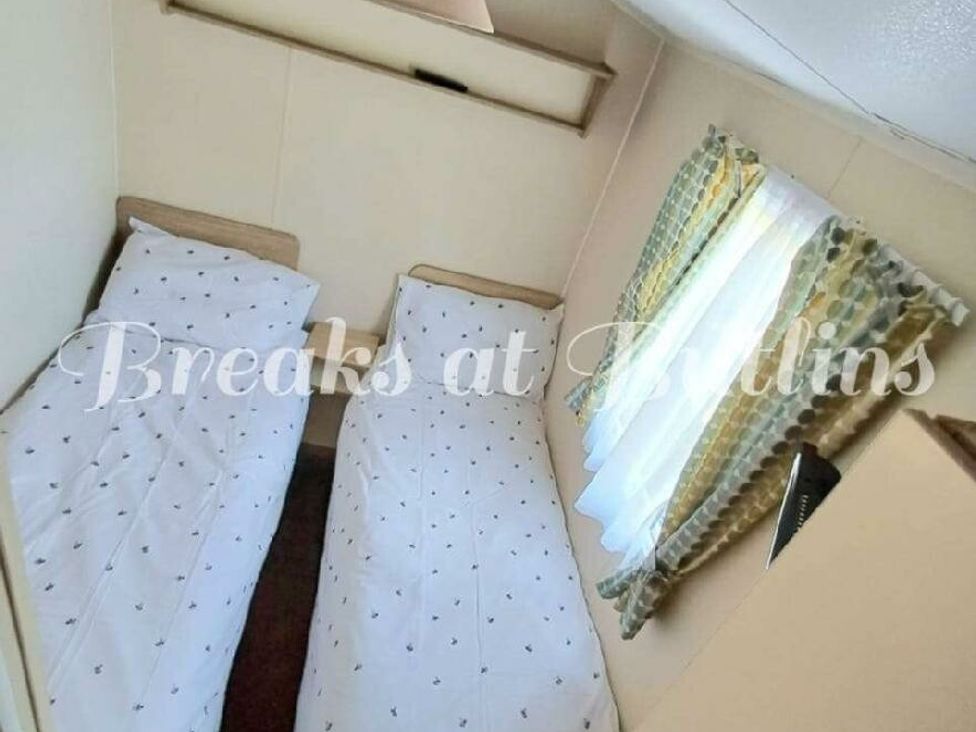 a bedroom with two single beds and a window with curtains at Butlins Minehead - Holiday Accommodation 18045 in Minehead